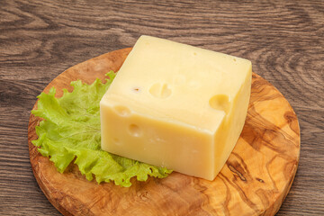 Emmental cheese over wooden board