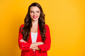 Portrait of her she nice attractive charming lovely cheerful cheery wavy-haired lady folded arms looking aside copy space isolated over bright vivid shine vibrant yellow color background