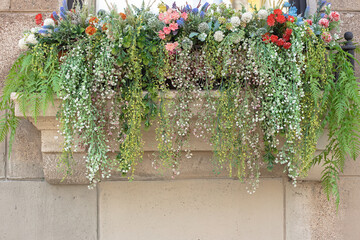 Naklejka premium flowers on the balcony, home decoration with plants, artificial plants for interior