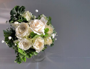 White roses flower arrangement in a glass vase.