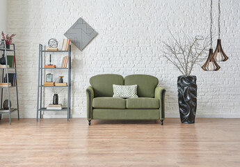 Green sofa in the living room with brick wall background and frame style, bookshelf lamp decor.