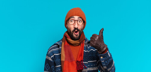 young crazy bearded man. happy and surprised expression and wearing winter clothes