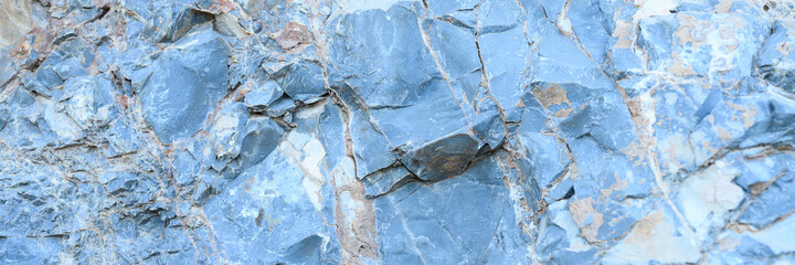 the texture of the surface of the gray blue natural stone rocks as a background. banner