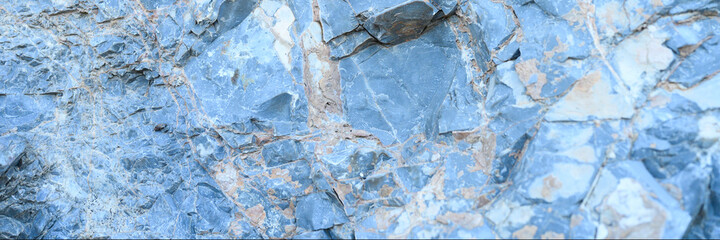 Obraz premium the texture of the surface of the gray blue natural stone rocks as a background. banner