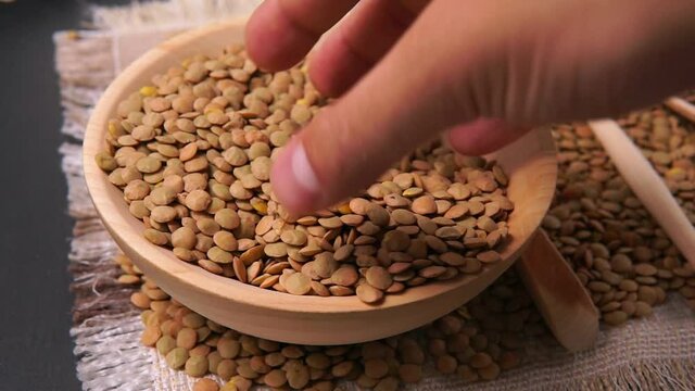 brown lentils in wooden bowl. Healthy lifestyle. Vegetarian and vegan diet.
