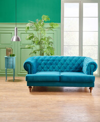 Green living room, classic wall background with blue sofa and lamp with vase of plant.