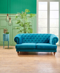 Green living room, classic wall background with blue sofa and lamp with vase of plant.
