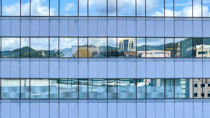 Naklejka na ściany i meble Beautiful modern tall tower with clouds in financial district. Windows skyline