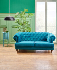 Green living room, classic wall background with blue sofa and lamp with vase of plant.