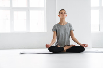 Attractive young woman practicing meditation