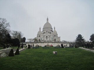 Panorama of the famous cathedral Sacre Coeur on a cloudy day. Scenic view of famous landmark in the morning.