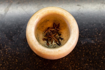 Mortar and pestle with spices. Witchcraft at home. Traditional cuisine.