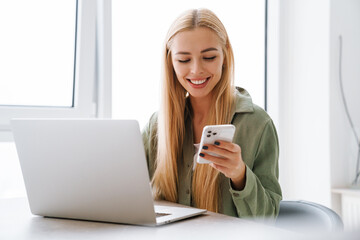 Happy smiling attractive young woman with laptop computer