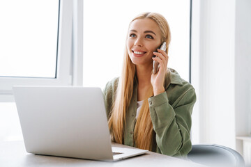 Happy smiling attractive young woman with laptop computer