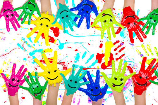 Many colorful self-painted children hands in front of white isolated studio background. Art,school,kindergarten,fun,funny hands and fingers of many children on photo.