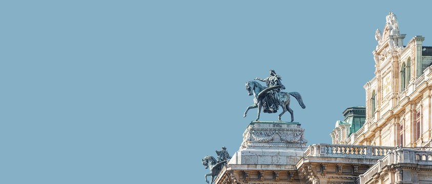 Banner with top roof sculpture of Greek goddess Muse riding Pegasus, a winged horse, at Vienna State Opera House, Vienna, Austria, with copy space. Concept of Cultural Heritage and Travel.