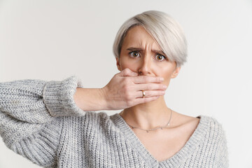 White-haired shocked young woman covering her mouth