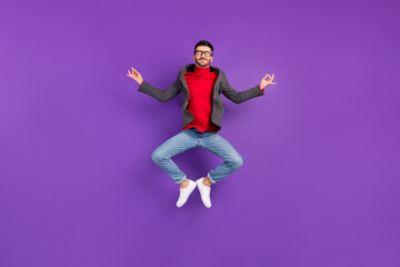 Full size photo of optimistic nice brown hair man jump wear spectacles sweater isolated on purple background