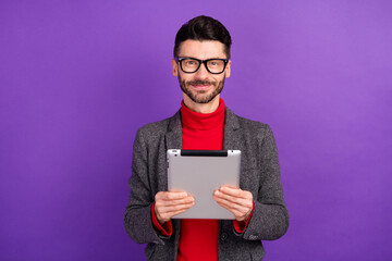Photo of optimistic nice brown hair man hold tablet wear spectacles red sweater jacket isolated on...