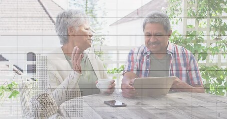 Statistical data processing against african american senior couple using digital tablet at home - Powered by Adobe