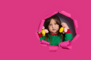 Cute little girls with holding easter eggs