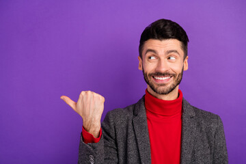 Photo of optimistic nice brown hair man point look empty space wear red sweater jacket isolated on purple color background