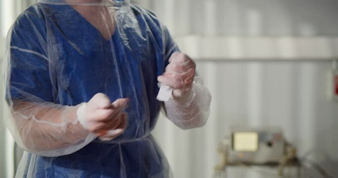 Closes up of surgeon putting off dirty gloves after surgery