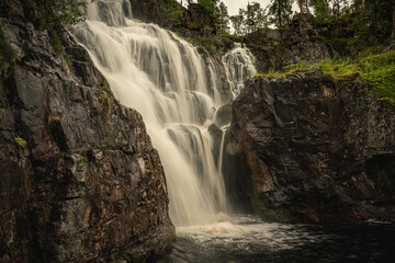 Fototapeta premium Waterfall flushing down a mountainside in northern Sweden