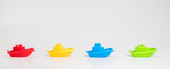 Plastic toys. Multi-colored boats on a white background.