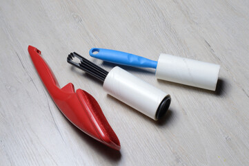 brushes for cleaning clothes. sticky and a bristled brush, lie on a light-colored countertop.