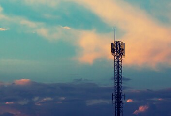 Obraz premium Telecommunication tower with sunset sky