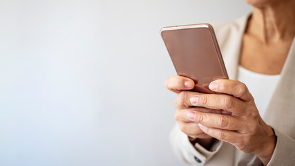 Surfing the net. Cropped shot of a businesswoman using a mobile phone in a modern office. Close up of a woman using her smartphone indoors.