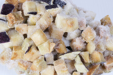 Fototapeta na wymiar Frozen eggplant sliced squared macro background. Frozen food