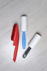 brushes for cleaning clothes. sticky and a bristled brush, lie on a light-colored countertop.