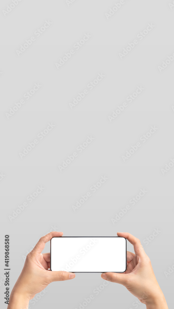 Poster vertical mockup hand holding mobile blank screen on grey background.mockup banner display of content