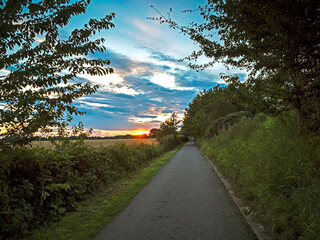 Beautiful sky at sunset seen from a shared footpath and cycle path forming a branch of the Trans Pennine Trail at Bishopthorpe, North Yorkshire, England