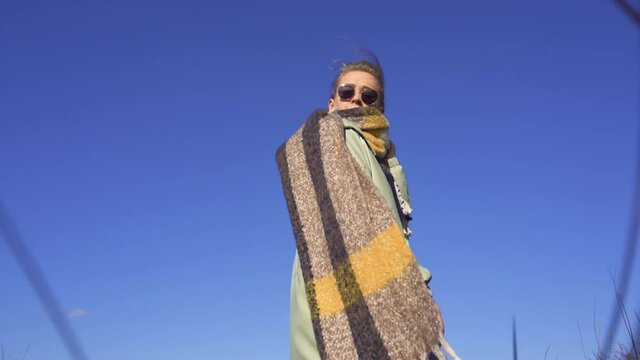 Slow Motion Beauty Shot of Stulish Young Girl in Scarf Staying in High Grass. Spring of Autumn Weather in Netherlands