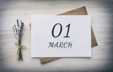 march 01. 01th day of the month, calendar date. White blank of paper with a brown envelope, dry bouquet of lavender flowers on a wooden background. Spring month, day of the year concept