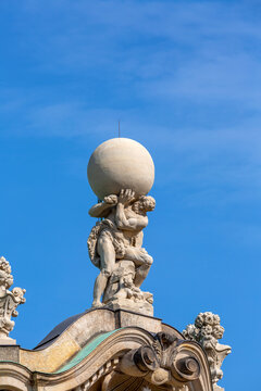 Dresden, Germany - September 23, 2020 : The mythological titan of Atlas on the top of Wall pavillon, 18th century baroque Zwinger Palace
