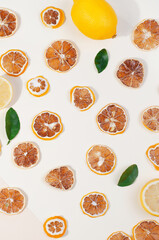 Dehydrated lemons slices on white background. Pattern with fruits chips