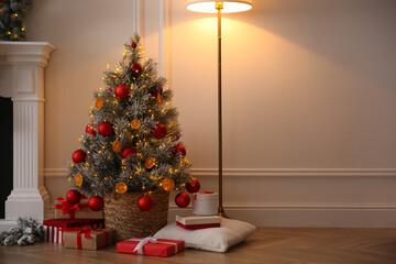 Beautiful Christmas tree and gift boxes in room. Space for text