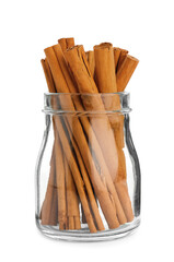 Aromatic dry cinnamon sticks in glass jar on white background