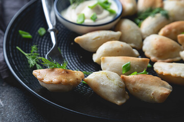 Dumplings, pelmeni, ravioli, pierogi on the table	