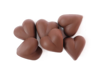 Delicious heart shaped chocolate candies on white background, top view