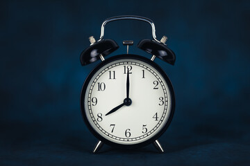 The time is eight o'clock in the morning. Time - 08-00. Retro clock. Dark background. Time to work....