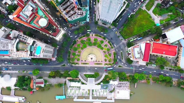 Time lapse Aerial city view, flying over a city, a suggestive perpendicular aerial video above a traffic roundabout with a lot of traffic, Vietnam Ho chi minh city. Timelapse
