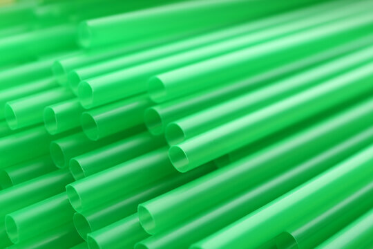 Heap Of Green Plastic Straws For Drinks As Background, Closeup