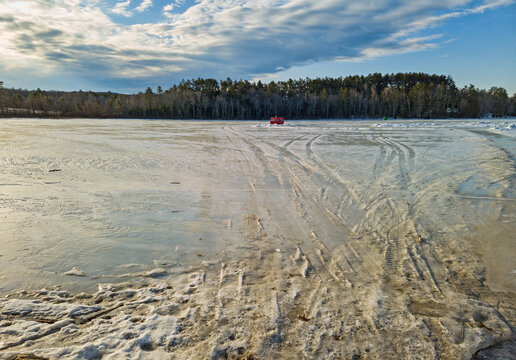 Ice Covered Norton Pond In Lincolnville Center Maine With An Old Camper As A Fishing Shack In The Winter.