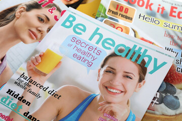Variety of women's modern magazines, closeup view