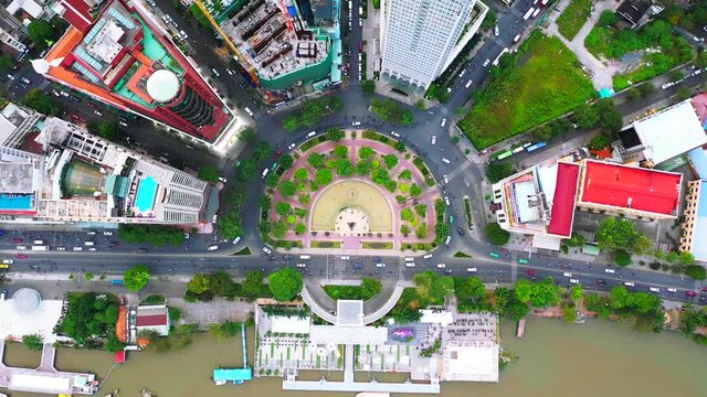 Time lapse Aerial city view, flying over a city, a suggestive perpendicular aerial video above a traffic roundabout with a lot of traffic, Vietnam Ho chi minh city. Timelapse

